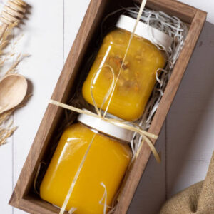 Set of jars with honey and nuts honey in wooden box top view, flat lay.