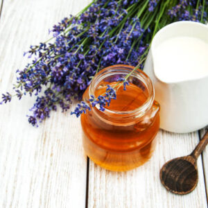 Honey and lavender flowers on a wooden table