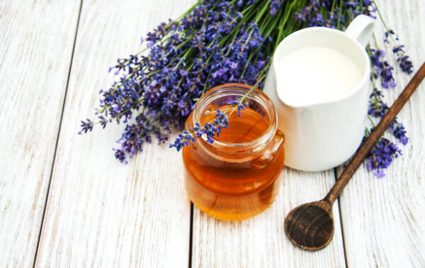 Honey and lavender flowers on a wooden table